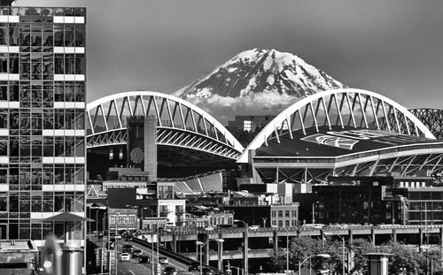 Bridge in city against sky