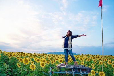 Woman standing on field against sky