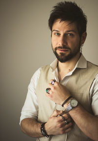 Portrait of young man against beige background