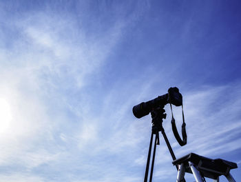 Low angle view of camera against blue sky