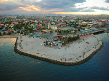 High angle view of buildings by sea against sky