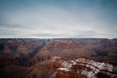 Scenic view of canyon against cloudy sky