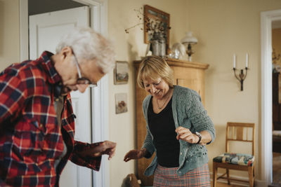 Senior couple dancing at home