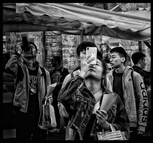 Full length of young couple looking at market