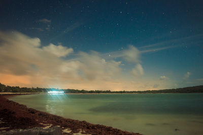 Scenic view of sea against sky at night