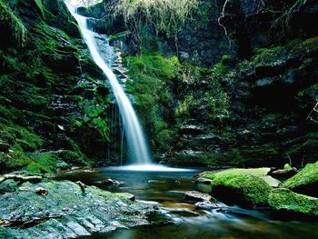 Scenic view of river flowing through rocks