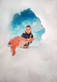 Digital composite image of woman against sky