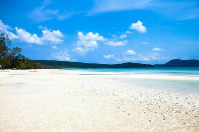 Scenic view of beach against blue sky