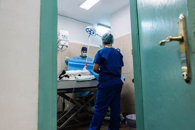 Rear view of man standing in corridor