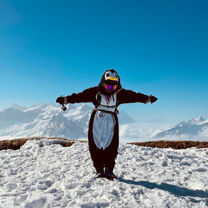 Rear view of woman standing on snow