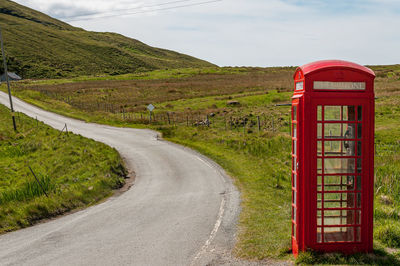 Isolated telephone booth near a road in the scottish highlands