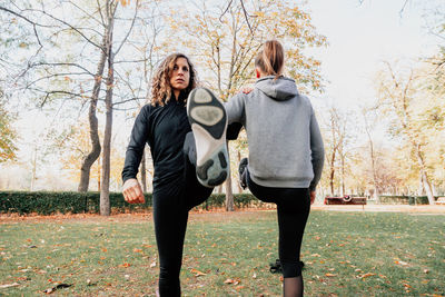 Low angle view of women exercising at park