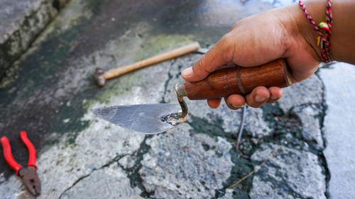 Close-up of hand holding rock