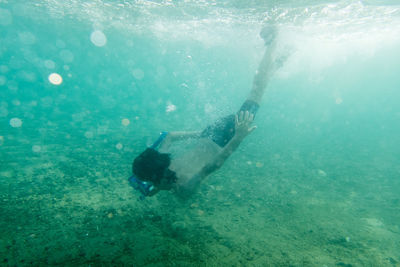 Shadow of person swimming in sea