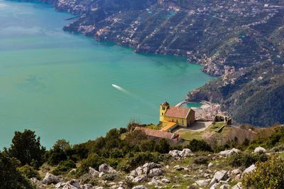 High angle view of sea by mountain