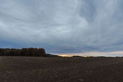 Scenic view of land against sky during sunset