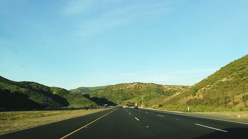 Empty road passing through landscape