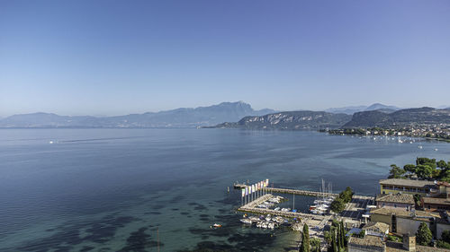 High angle view of townscape by sea against sky