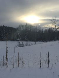 Scenic view of snow covered landscape against sky during sunset