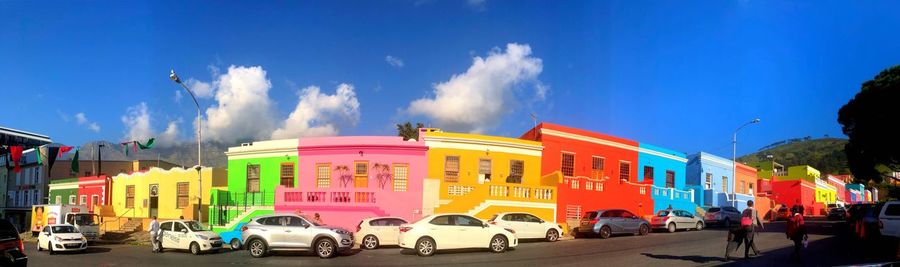 Panoramic view of buildings against blue sky