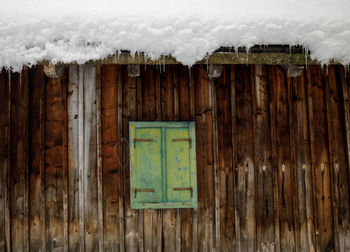 Closed wooden door of building during winter