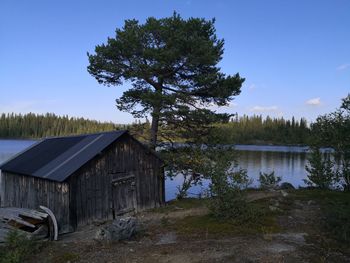 Scenic view of lake amidst trees in forest against sky