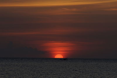 Scenic view of sea against romantic sky at sunset