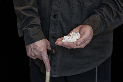 Midsection of man holding hands