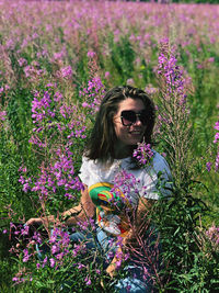 Portrait of woman on purple flowering plants
