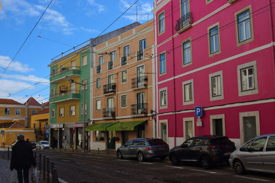 Cars on road by buildings in city