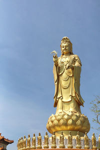 Low angle view of statue against sky