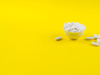 High angle view of yellow drink on table