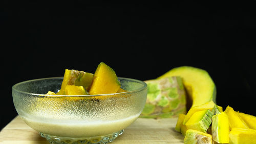 Close-up of fruit on table against black background