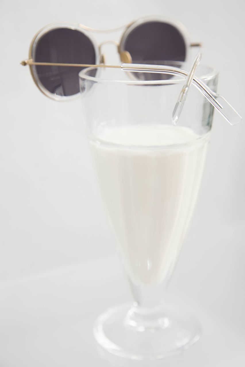 CLOSE-UP OF DRINK ON WHITE TABLE