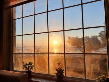 Scenic view of orange sky seen through window