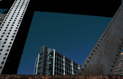 Low angle view of modern building against blue sky