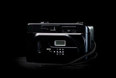 Close-up of camera phone against black background