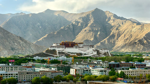 Houses in city against mountain range