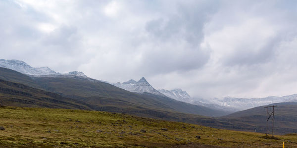 Scenic view of mountains against cloudy sky