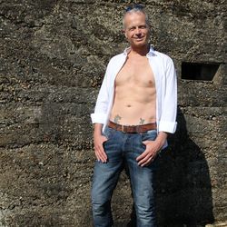 Portrait of smiling man standing against wall