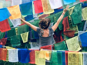Rear view of woman standing at market stall