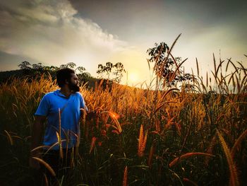 Man standing on land against sky 