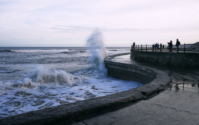 Scenic view of sea against sky and a big wave