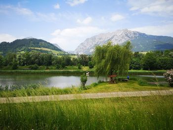 Scenic view of lake and mountains against sky