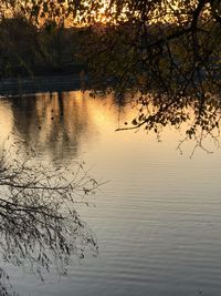 Scenic view of lake against sky at sunset