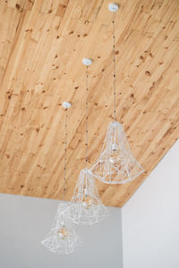 Low angle view of illuminated pendant light hanging from ceiling