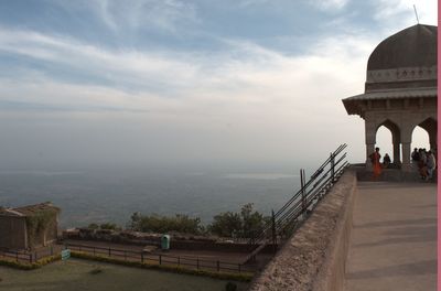 Built structures against cloudy sky