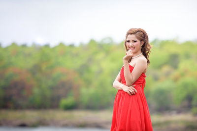 Portrait of young woman standing outdoors