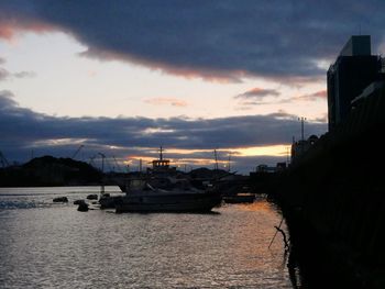 Boats in city against sky