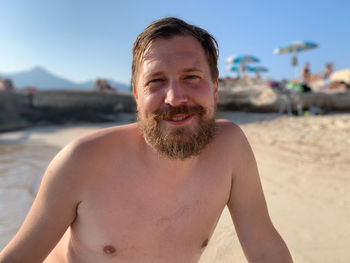 Portrait of shirtless man at beach